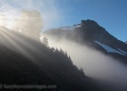 Crossing a saddle, the cloud deck spills over and across the trail.