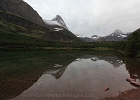 Overcast, but mirror still Redrock Lake along the Swiftcurrent Pass trail. 8851-ft Mt. Grinnell (L), Swifcurrent Mt (R), Swiftcurrent Pass (C).