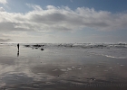 My favorite beach partner reflected in the wet sands of Moolack Beach.  Yaquina Head distant.
