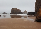 The foggy side of a headland obscured Arch Rocks and Cape Mears.