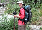 Iceberg Lake Trail: Yvonne sports a spiffy new hat as we pause at the falls.