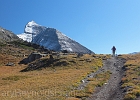 Yvonne crests 7540&#39; Piegan Pass, with 10,014&#39; Mount Siyeh behind.