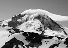 A cap cloud forms quickly on Baker&#39;s summit.  The forecast predicted a change, but the cap melted away soon after this shot was taken.